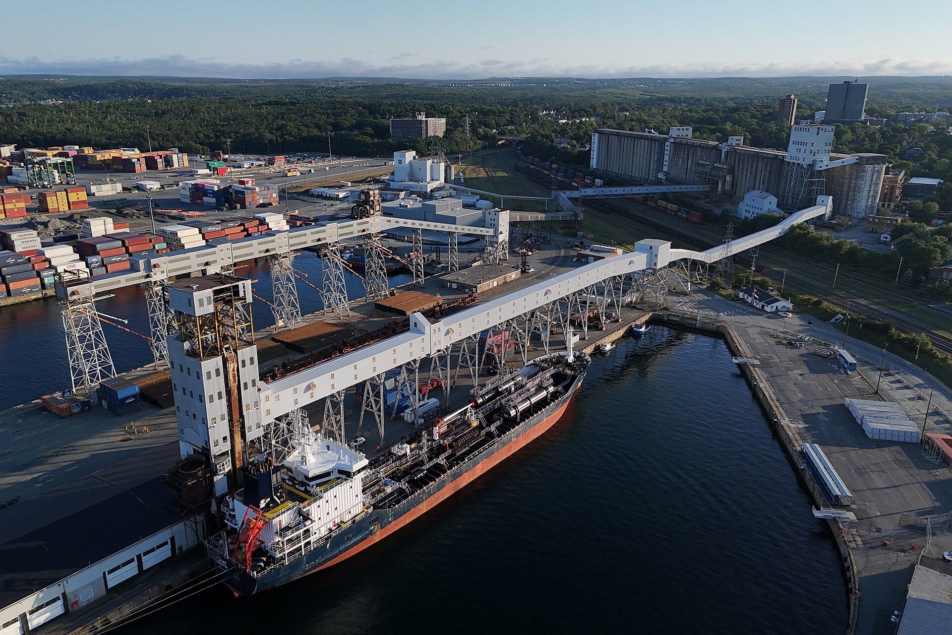 Aerial view of a bulk carrier berthed under a grain elevator's loading gallery